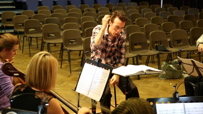 Conductor Alisdair Kitchen at rehearsal