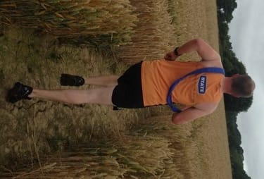 The blue sash of winners Weald Tri Club crosses a field
