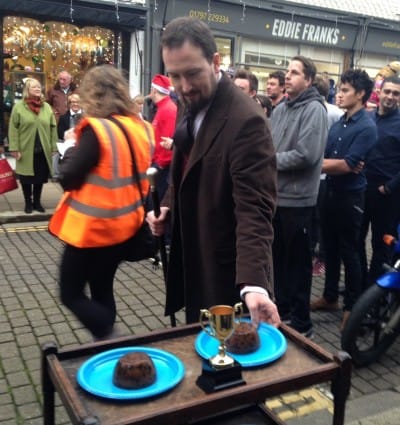 A competitor weighs up the Xmas pudding before the race begins