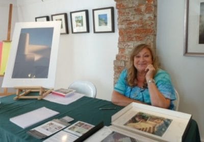 Photographer Desi Fontaine with some of her work